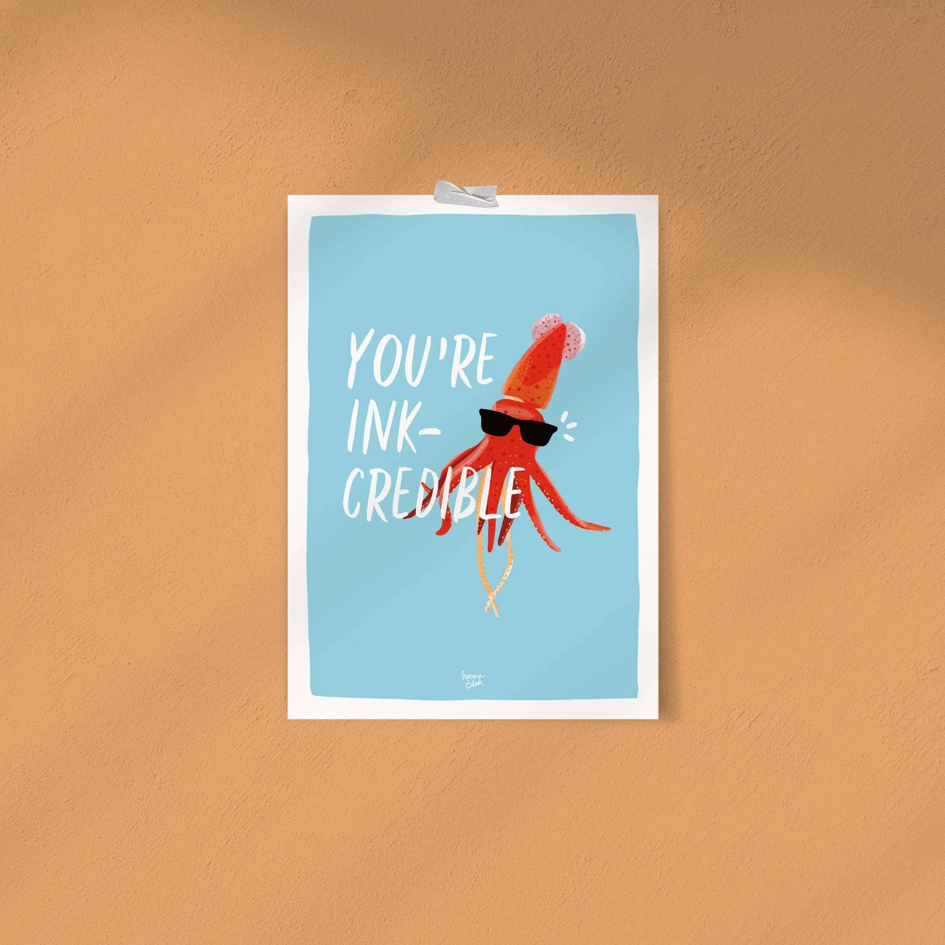 The funny digital squid illustration with sunglasses attached directly to a solid, vibrant orange wall using simple, colorful strips of washi tape. This shot demonstrates a casual, budget-friendly, and modern way to style the art print without using a traditional frame.