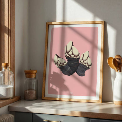 Framed goose barnacle art print displayed on a kitchen shelf, illuminated by soft natural light coming from a nearby window. This kitchen decor setting highlights how the pink background brings warmth to the space.