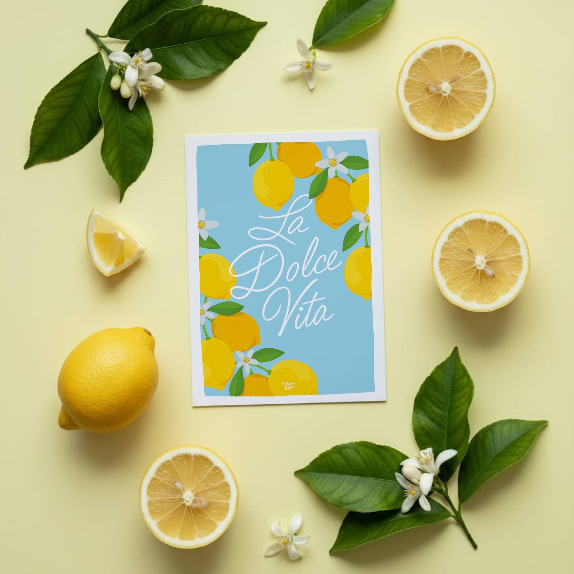 Escape to Amalfi with the La Dolce Vita mini print by Normablok. This A6 digital illustration features vibrant lemons and hand-drawn script on sky blue. Perfect for your desk or as a gift, each print includes a white border for easy framing. High-quality art to brighten your space.
