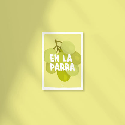 A vibrant A6 postcard with a light green background featuring a detailed digital illustration of a bunch of green grapes with the text "en la parra" written in a modern, casual font above the fruit by normablok.