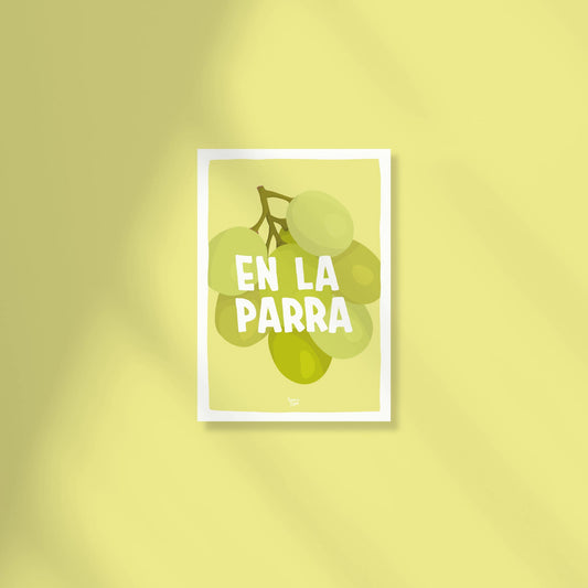 A vibrant A6 postcard with a light green background featuring a detailed digital illustration of a bunch of green grapes with the text "en la parra" written in a modern, casual font above the fruit by normablok.