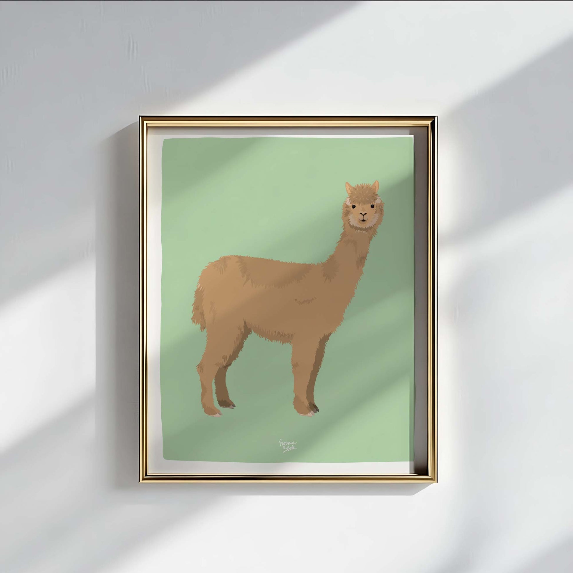 A stunning alpaca art print displayed in a luxurious gold frame. The metallic finish adds a touch of sophistication to the cozy illustration, demonstrating how wildlife art can elevate the decor of a refined and modern living room.
