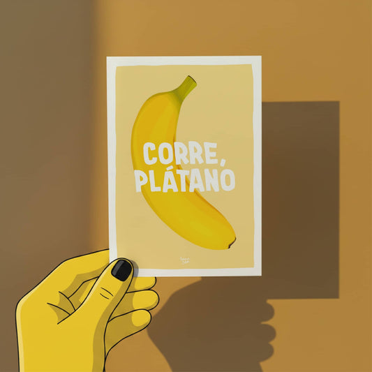A hand holding the A6 banana pun card against a neutral background to show the size and the clean white border by Normablok.