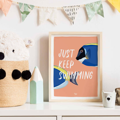 The fish art print in a minimalist black frame hanging inside a contemporary living room. It sits above a wooden shelf next to a green potted plant, showing how this humorous and colorful design brings energy and a modern touch to a home workspace.