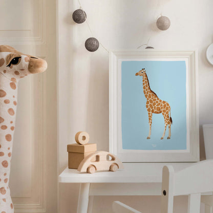 The reticulated giraffe art print in a sleek white frame within a cozy, modern nursery. Styled with a cute plush giraffe toy, this kids' room decor shows how wildlife illustrations create a playful, educational, and aesthetic environment for children.