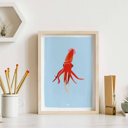 Squid art print framed and placed on a desk next to a pencil holder, demonstrating an example of office wall decor and workspace styling.