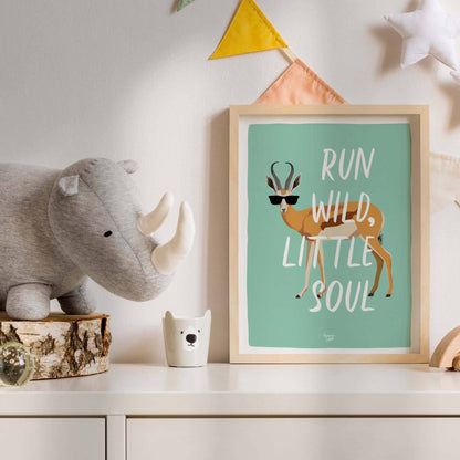 The antelope art print in a light wooden frame hanging inside a contemporary kids' bedroom. It is styled next to a wooden toy shelf and a woven basket, showing how this humorous and free-spirited design brings life and a modern touch to a children's space.