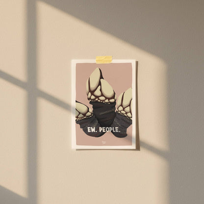 An A6 "Ew. People." barnacle mini print taped with patterned washitape to a warm salmon pink wall in a cozy room with soft natural lighting by Normablok.