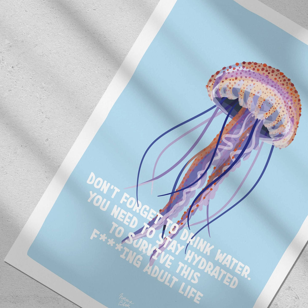 A close-up top-down flat lay focusing on a section of the art print, showing the jellyfish texture and its English quote.