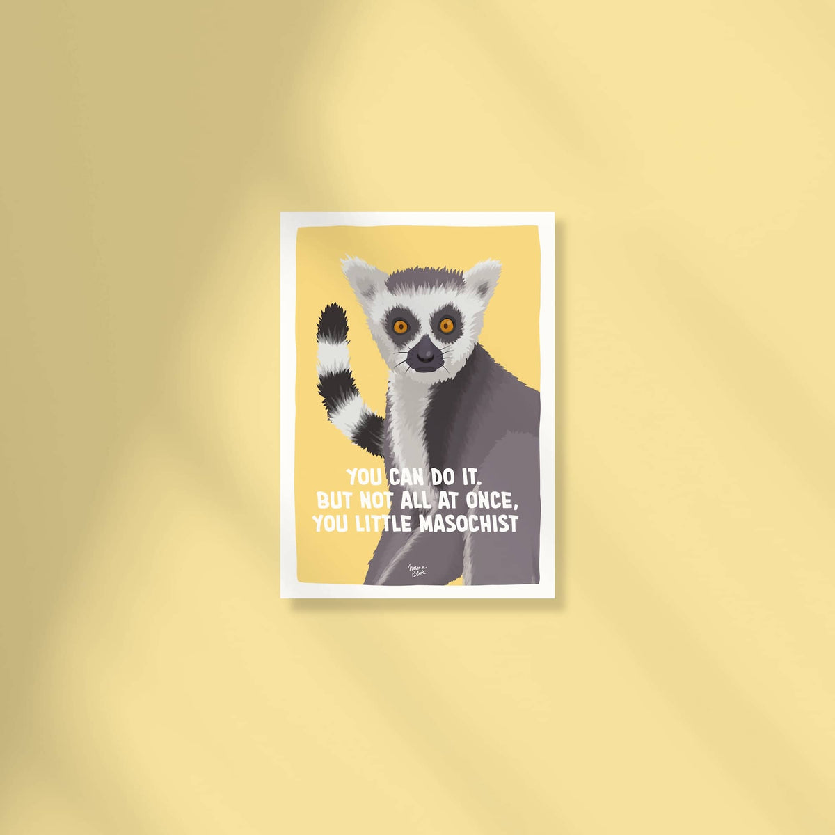 A full front-facing flat lay product image showing the complete A6 mini print artwork centered against a matching color background. The digital illustration features a quirky ring-tailed lemur with wide expressive eyes staring directly forward on a vibrant yellow backdrop, with the sarcastic quote "You can do it. But not all at once, you little masochist." rendered in clean typography. The shot clearly displays the entire composition, sharp details, and clean white border framing the print by Normablok.