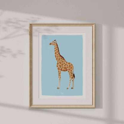 Elegant giraffe print in a luxurious gold frame hanging on a crisp white wall. Natural light and shadow play emphasize the premium quality of the print, showcasing how luxury wall art transforms modern interior spaces into curated home galleries.