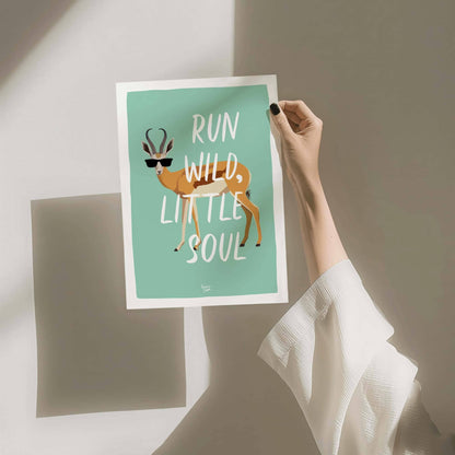 A close-up shot of a person's hand holding the printed antelope illustration, providing a real-life physical reference for the scale, matte paper quality, and vibrant turquoise color finish. This perspective helps customers visualize the print size easily.