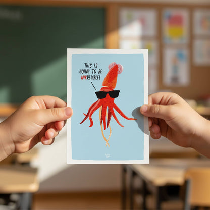 A kid holding the A6 squid postcard to showcase its size and give it to another child, perfect for sending as a thank you note or a party invite by Normablok.