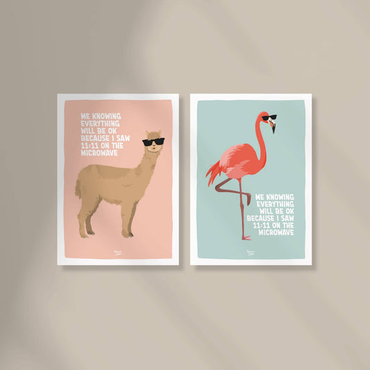 Two A6 mini prints from the "Delulu is the solulu" collection by Normablok featuring a flamingo and an alpaca with sunglasses. The text "me knowing everything will be ok because I saw 11:11 on the microwave" highlights a modern, humorous approach to spiritual signs and mental health reminders.