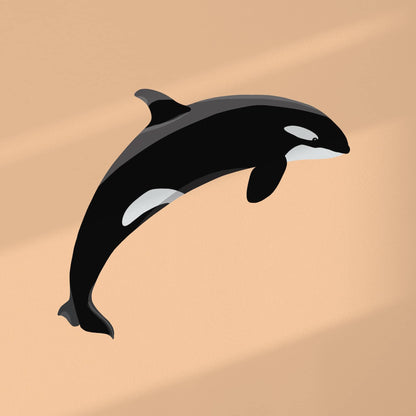 Digital art print of an orca silhouette against a bold, vibrant orange background, highlighting the contrast and clean design of the illustration.
