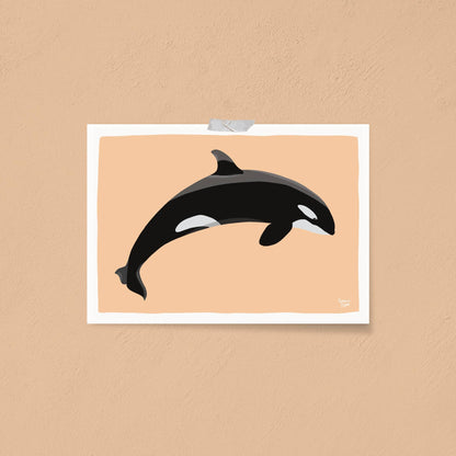 Orca art print attached directly to an orange wall using clear tape. This minimalist display focuses on the striking contrast of the black-and-white orca illustration against the vibrant orange background, creating a bold and casual wall decor aesthetic.