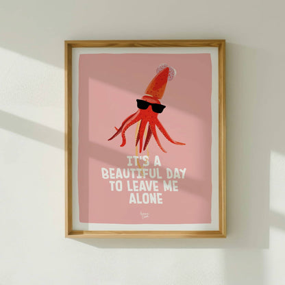 The antisocial squid art print framed in light wood, hanging on a white wall with natural window light by Normablok.