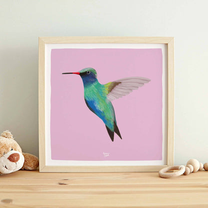The hummingbird digital illustration adapted into a square format layout, framed and hanging on a wall in a cheerful children's bedroom. The clean white border and balanced composition add a contemporary touch to the room's playful atmosphere.